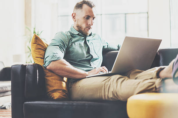 istock Bearded Hipster working Laptop modern Interior Design Loft Office.Man 543827026