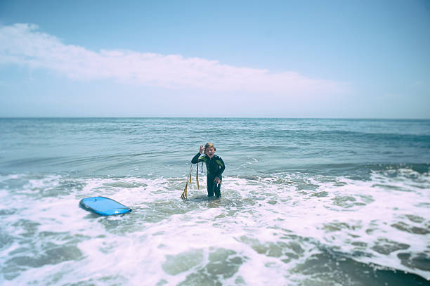 Young boy boogie boarding in California
