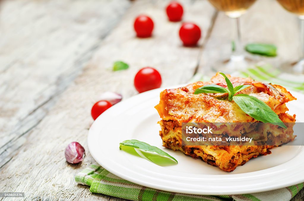 Meat lasagna Meat lasagna on a white wood background. toning. selective focus Lasagna Stock Photo