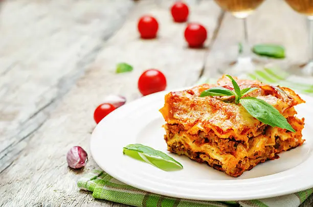 Meat lasagna on a white wood background. toning. selective focus