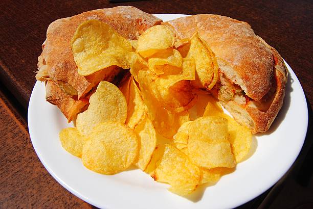 Traditional Maltese bread sandwiches ftira with potato chips.