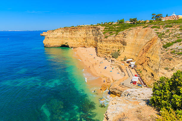 istock View of beach with golden color cliff rocks 543832936