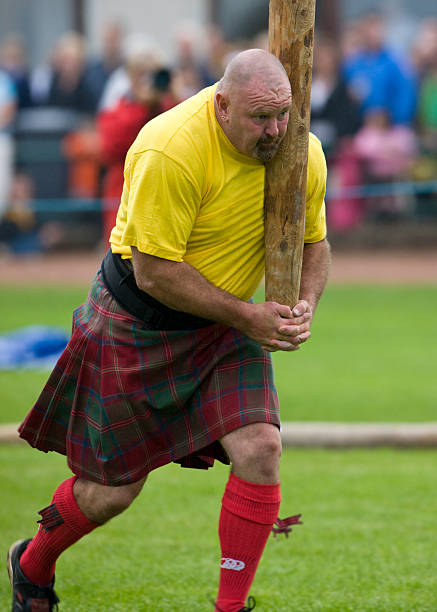Highland Games - Scotland Dunoon, United Kingdom - August 30, 2008: Sportsman 'tossing the caber' at the Cowal Gathering - a traditional Highland Games near Dunoon on the Cowal Peninsula in Scotland. sporran stock pictures, royalty-free photos & images