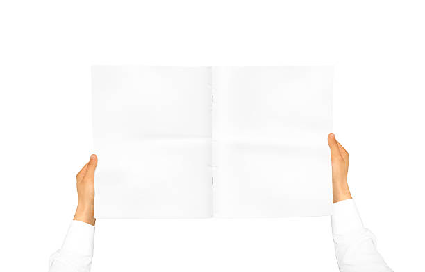 istock Hand in white shirt sleeve holding blank journal 543835214