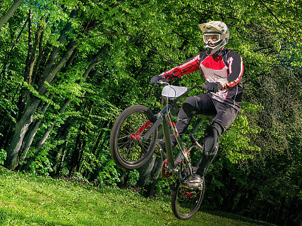 istock Young bmx bicycle rider on background of trees 543835486