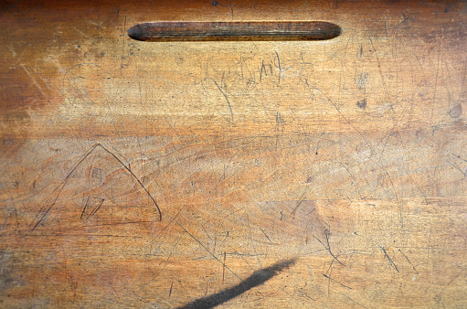 A top view image of an old wooden school desk.