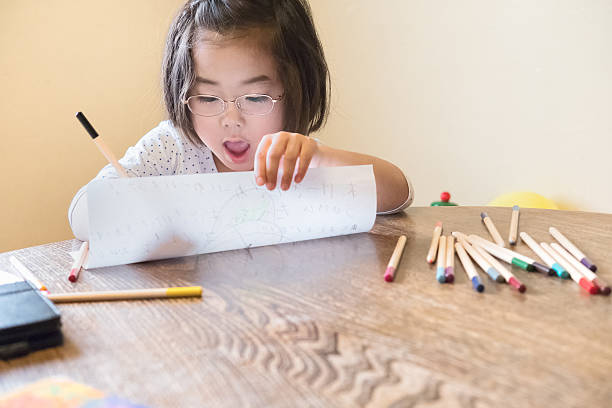istock Happy Young Japanese Girl Drawing with Pencil Crayons at Home 543837708