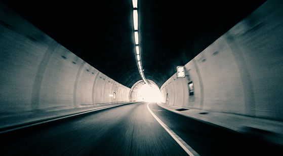 Highway leading through a mountain tunnel in Norway, with a speedy blur.