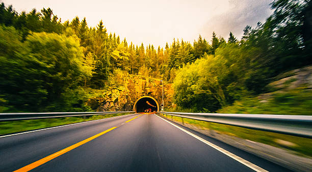 istock Highway leading towards a mountain tunnel, Norway 543838458