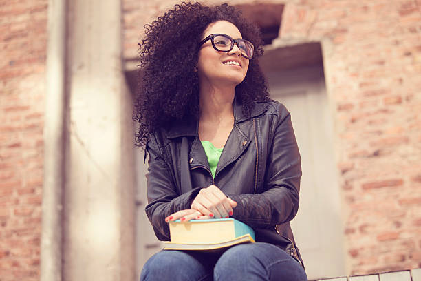 African american young woman with books stock photo