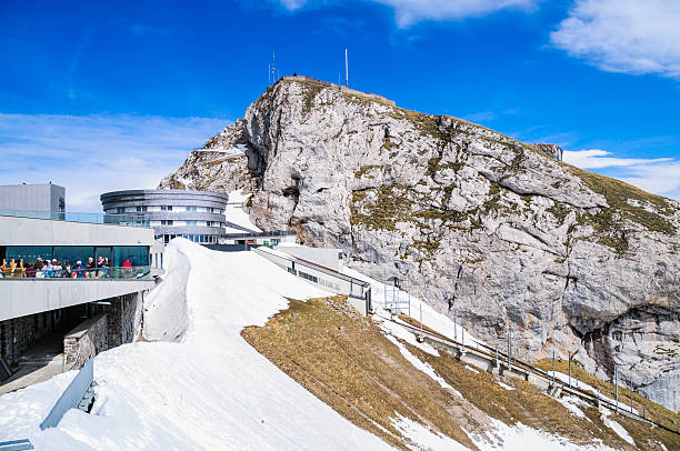 Lucerne, Switzerland - May 22, 2016: Visitors to the summit of Mt. Pilatus in Lucerne gather on the ougtside deck to enjoy the view or take photographs.