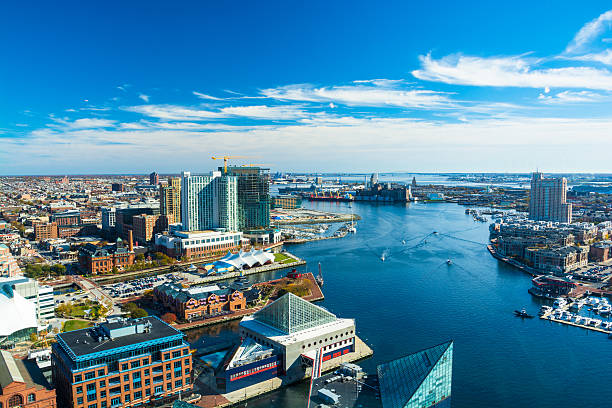Baltimore Aerial with Patapsco River / Waterfront Aerial of Baltimore City with the Patapsco River and waterfront buildings.  Harbor East and Fells Point neighborhoods is shown on the left and the Tide Point neighborhood is shown on the right. acute angle photos stock pictures, royalty-free photos & images