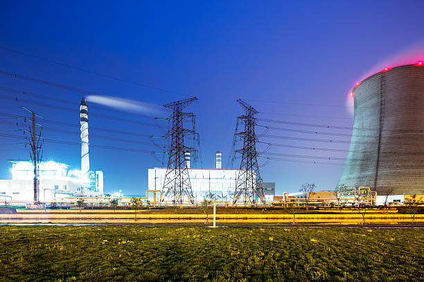 istock cooling tower and high chimney in modern power station twilight 543843120