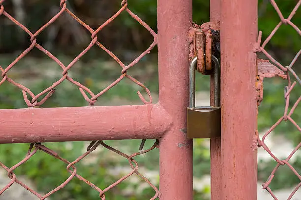 Photo of Close up Metal fence and padlock background. (Selective focus)