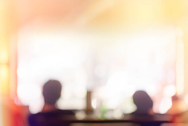 defocused people sitting in coffe shop, friends hanging out on a bright sunny summer day