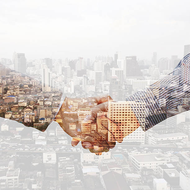 istock Double exposure of handshake with night city blured background. 543844914
