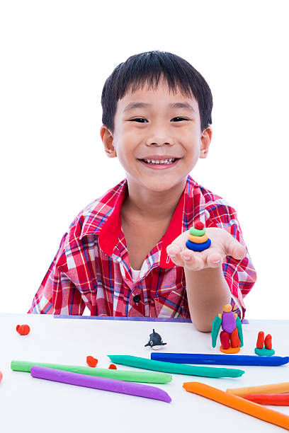 istock Child smiling and show his works from clay, on white. 543845024