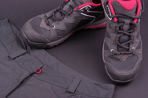istock Women's hiking boots and trousers on black background 543974072