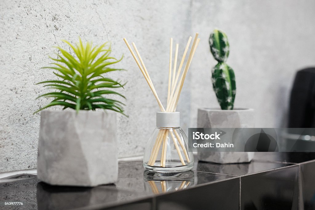 Air fresher and house plants on black tiles Air fresher and house plants in pots on the stone black tale closeup Air Freshener Stock Photo