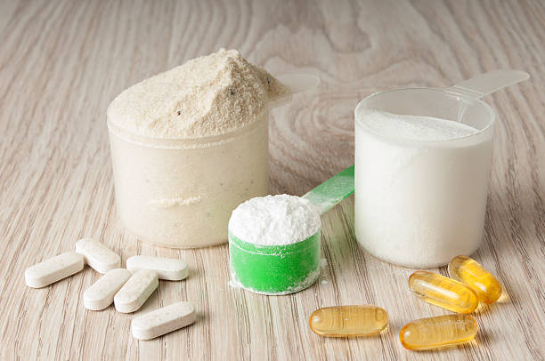 istock scoop of protein, bcaa and creatine, omega3 in pills 543978028