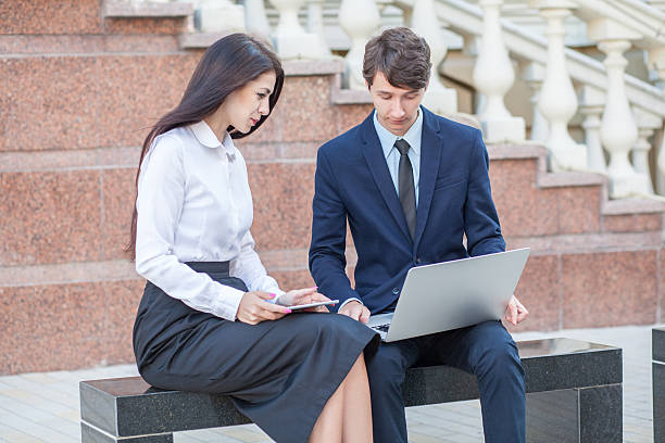 istock Boss and his assistant discussing their work outdoors. 543979726