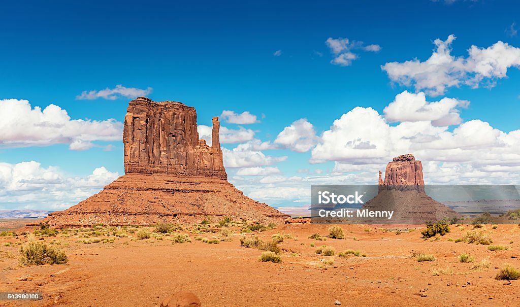 West Mitten and Merrick Butte Monument Valley Arizona Scenic view to the famous West Mitten Butte and Merrick Butte under beautiful summer sky. Monument Valley, Arizona, USA. Monument Valley Stock Photo