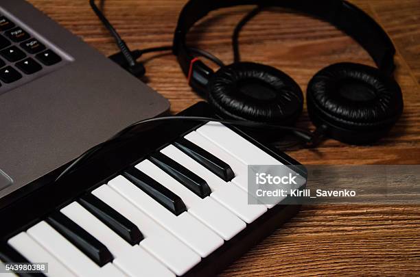 Laptop Synthesizer And Headphones On A Wooden Table Stock Photo - Download Image Now
