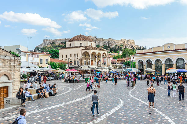 Monastiraki Square in Athens, Greece Athens, Greece - June 9, 2016: Monastiraki is a flea market neighborhood in the old town of Athens, Greece, and is one of the principal shopping districts in Athens. The area is named after Monastiraki Square, which in turn is named for the Church of the Pantanassa that is located within the square. Photo taken durign the day and contains many locals and tourists visiting the square. plaka athens stock pictures, royalty-free photos & images