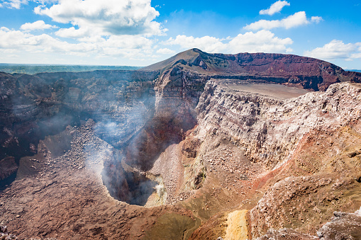View down to the aktive smoking Santiago Crater of the Pyroclastic Shield Masaya Volcano. Masaya Volcano National Park, south of Managua, Nicaragua.