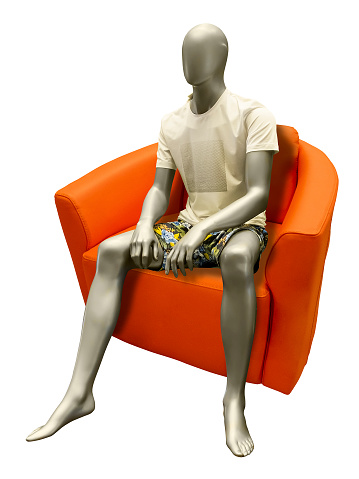 Sitting male mannequin wearing summer dress. Isolated on white background.  No brand names or copyright objects.