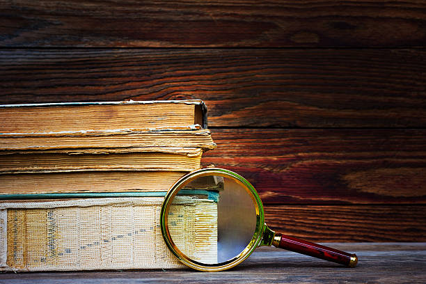 istock old books and magnifier on wooden background 543986928