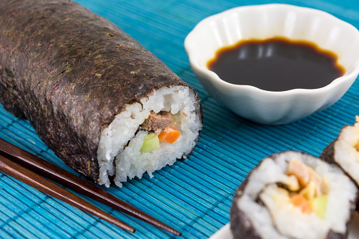 Sushi roll soy sauce and wooden chopsticks