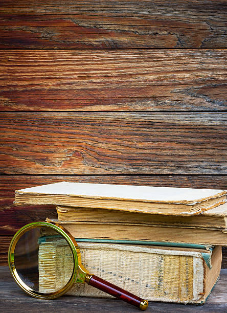 istock old books and magnifier on wooden background 543987060