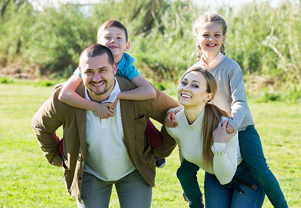 istock Parents holding kids on shoulders 543988464