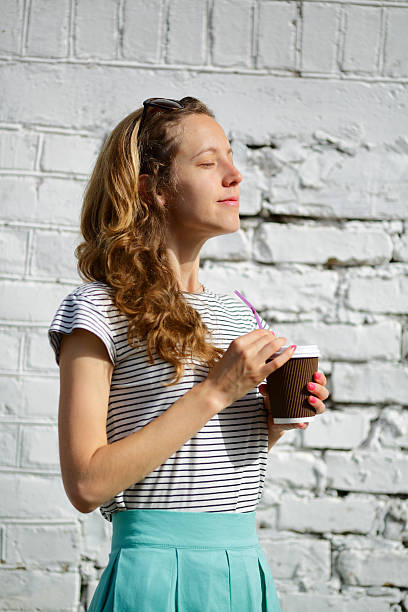istock Happy young woman with a disposable coffee cup 543988684