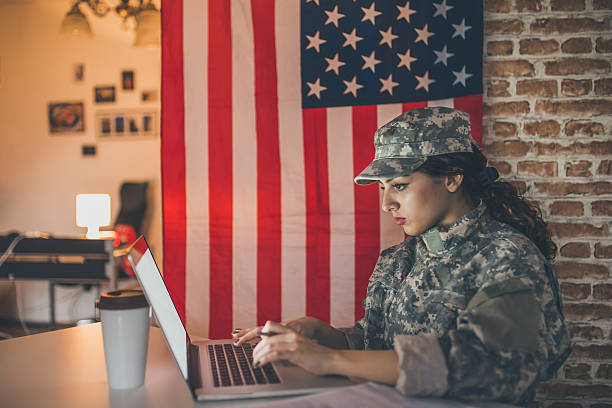 istock Female soldier using laptop in her modern office 543988746
