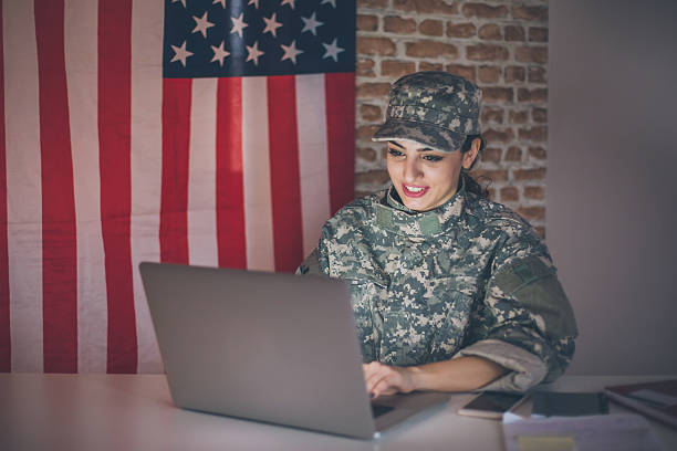 istock Female soldier using laptop in her modern office 543990328