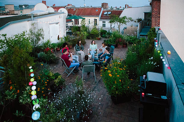 istock young adults, roof garden, talking, smoking Hookah 543992750