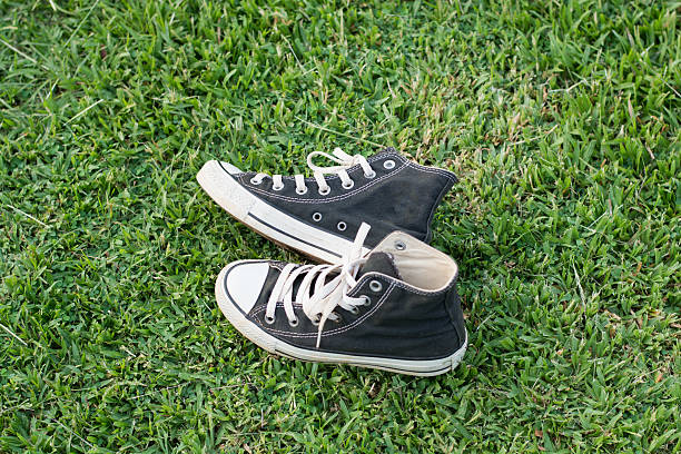 istock black sneakers on green grass 543994520