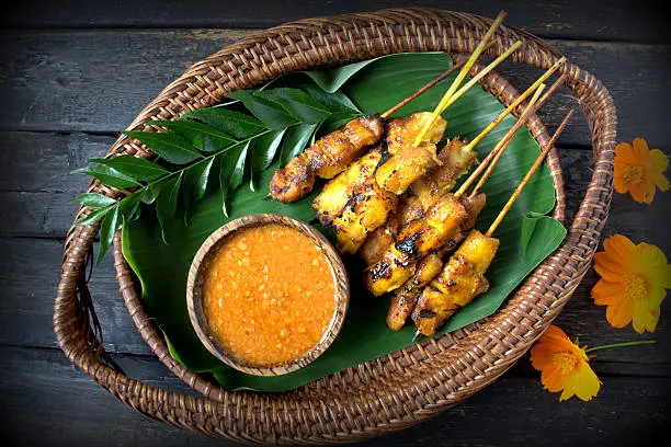 Chicken Satay or Sate Ayam - Malaysian famous food. Satay, modern Indonesian and Malay spelling of sate, is a dish of seasoned, skewered and grilled meat, served with a peanut sauce