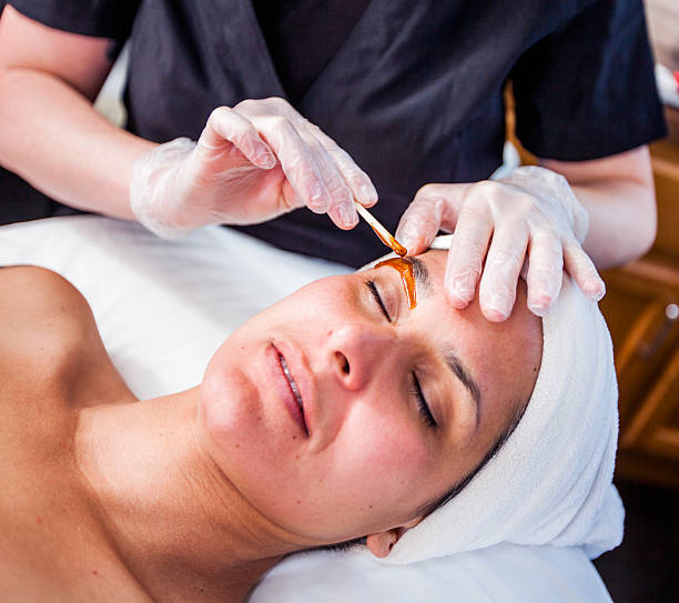 Woman Getting Her Eyebrows Waxed stock photo