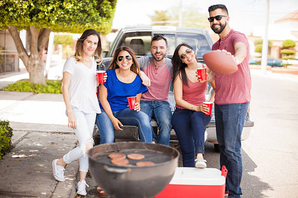 istock Football fans tailgating at a game and drinking 543996488