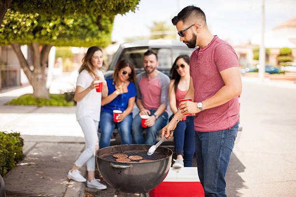 istock Young man with a beard grilling some burgers 543996986