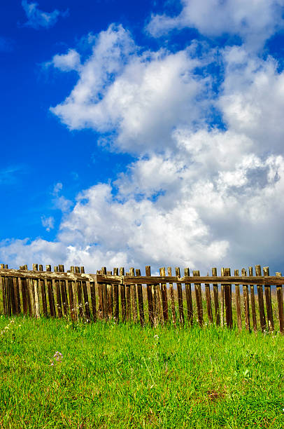 istock Rustic Wood Fence, Wildflowers and Cloudy Sky 543997964