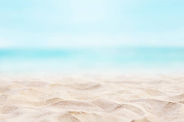 Background Summer Close up sand with blurred sea sky background, summer day standing water stock pictures, royalty-free photos & images