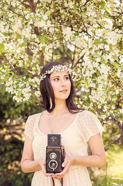 Bridal portrait in a flower crown with old camera