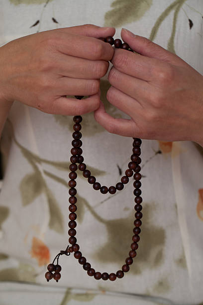 istock Woman's hands holding meditation beads 543999122