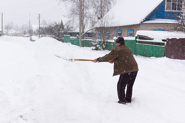 istock man cleans snow shovel 543999186