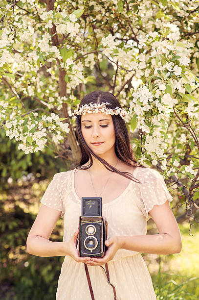 istock Bridal portrait in a flower crown with old camera 543999354