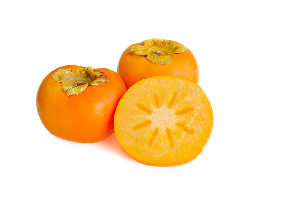 istock Fresh persimmon fruit sliced and whole isolated on white 543999574